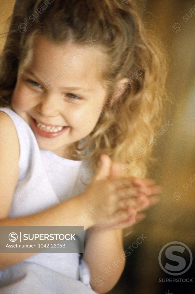 Stock Photo: 1042-2305B Girl clapping her hands