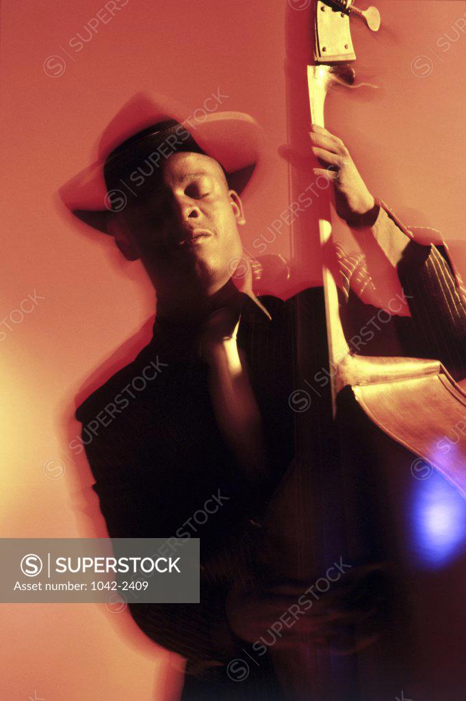 Stock Photo: 1042-2409 Close-up of a young man playing a double bass
