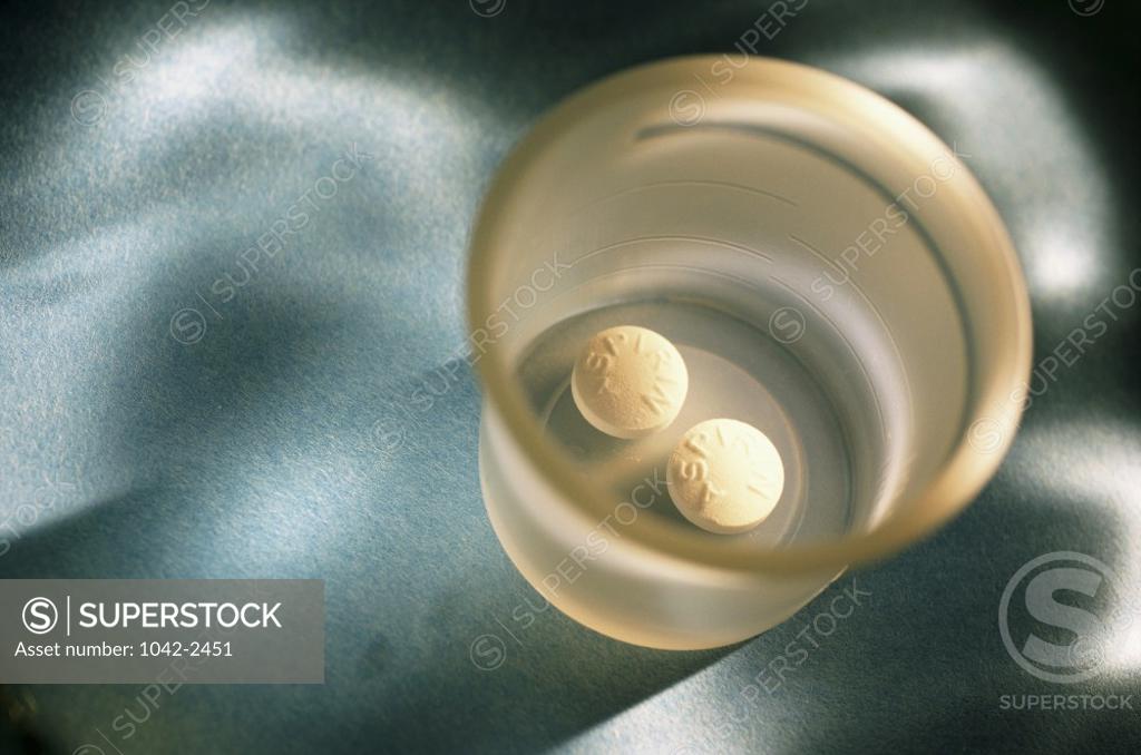 Stock Photo: 1042-2451 High angle view of two pills in a cup