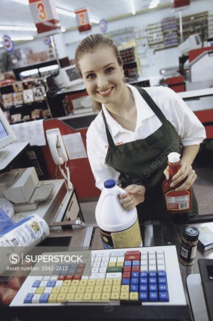 Stock Photo: 1042-2615 Portrait of a female cashier at the checkout counter in a supermarket
