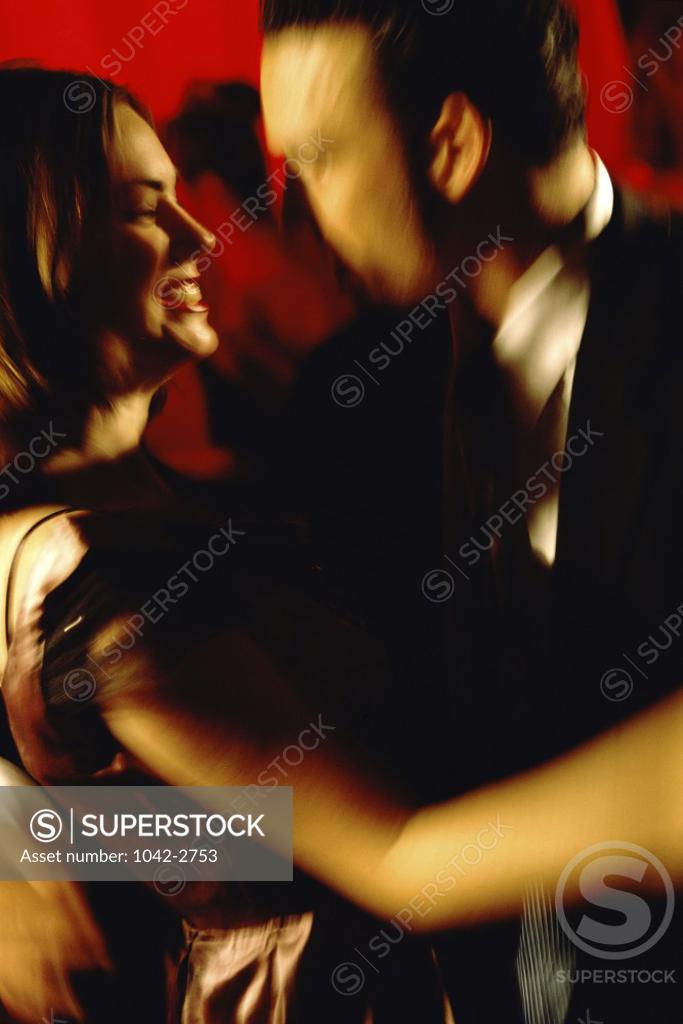 Stock Photo: 1042-2753 Side profile of a young couple dancing in a nightclub