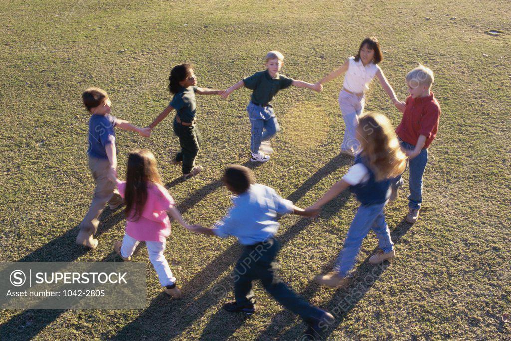 Stock Photo: 1042-280S High angle view of a group of children playing ring-around-the-rosy