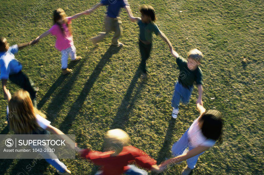 Stock Photo: 1042-282D High angle view of a group of children playing on a lawn