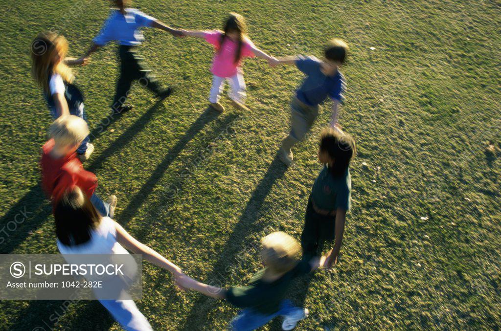 Stock Photo: 1042-282E High angle view of a group of children playing on a lawn