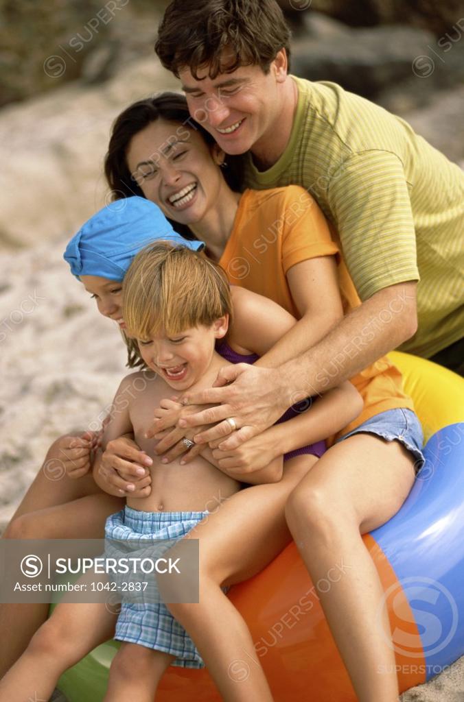 Stock Photo: 1042-2837 Young couple playing with their son and daughter