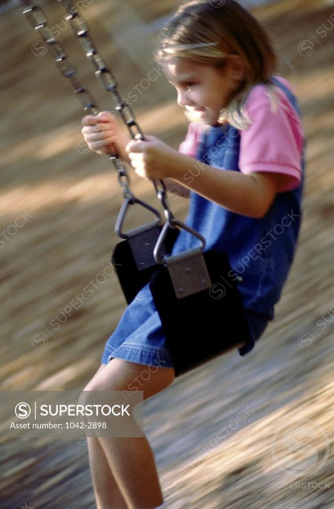 Stock Photo: 1042-2898 Side profile of a girl swinging on a swing