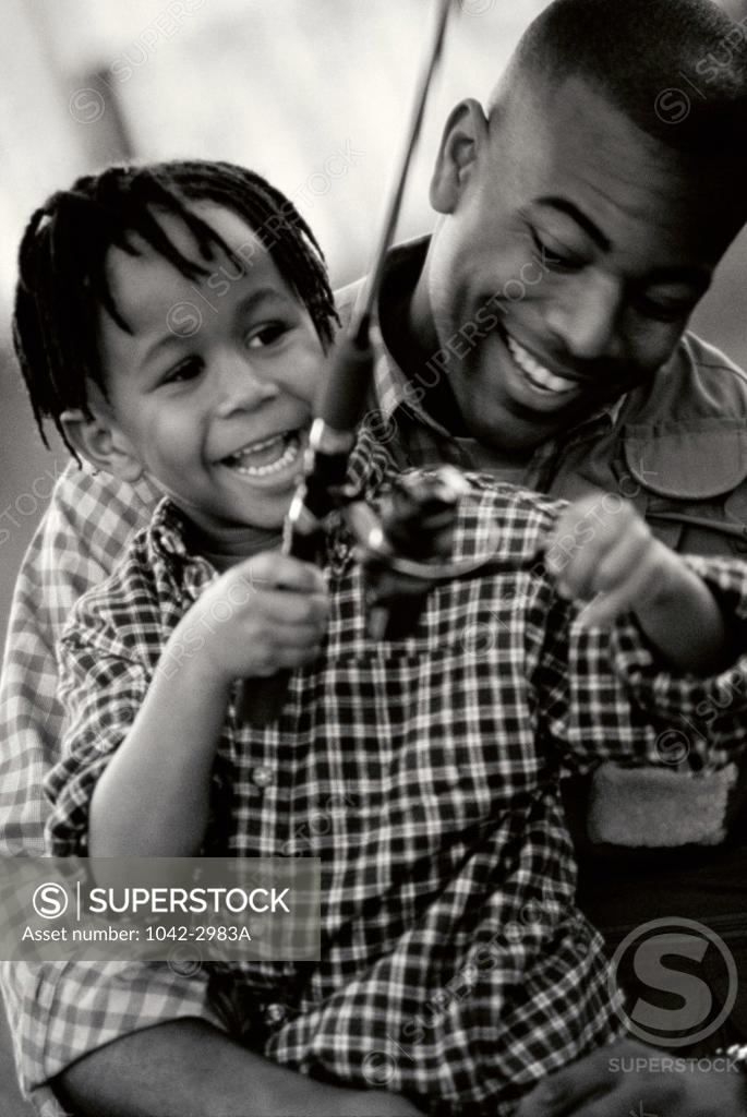 Stock Photo: 1042-2983A Father and his son fishing