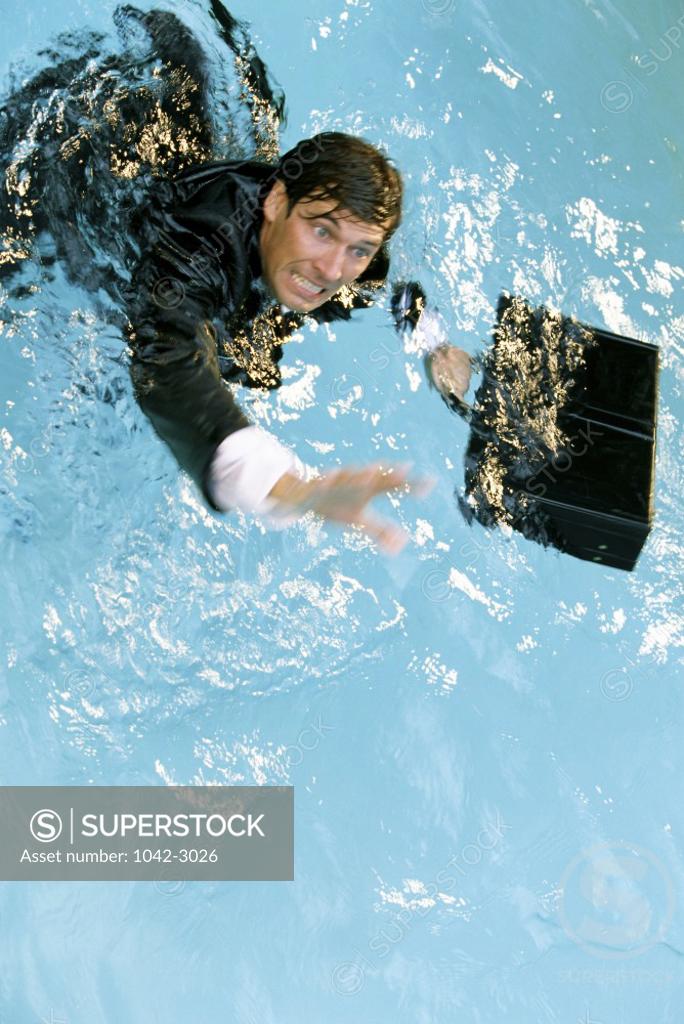 Stock Photo: 1042-3026 Businessman in water with a briefcase
