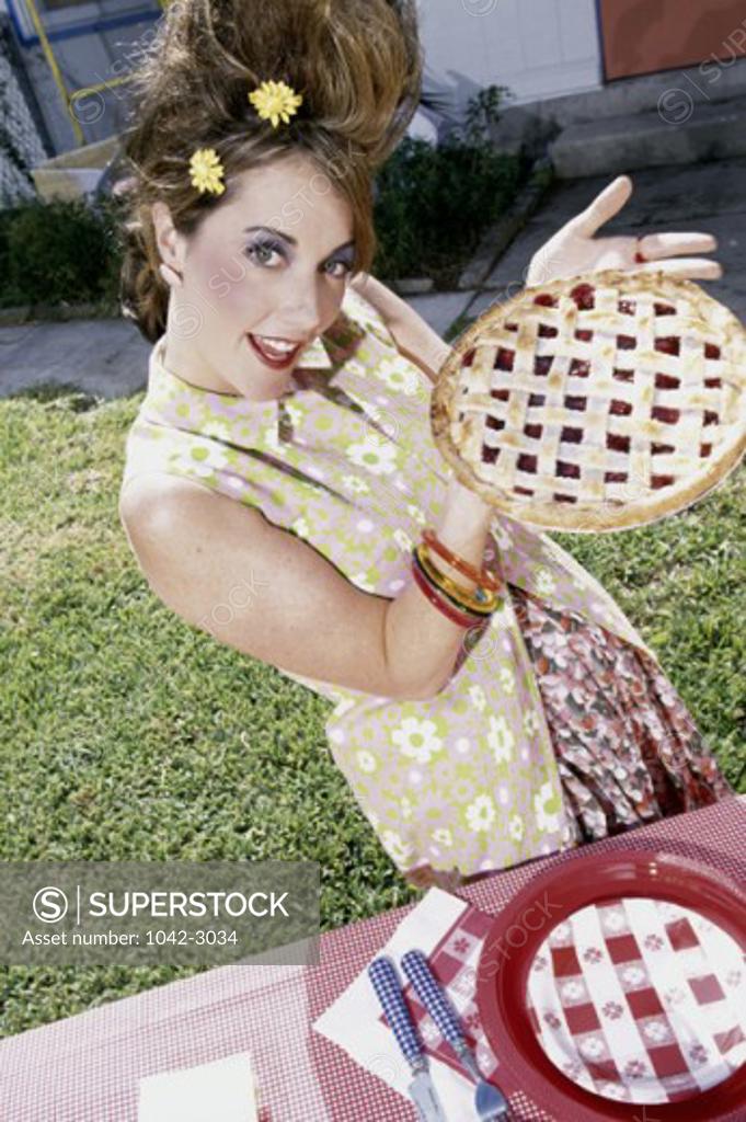 Stock Photo: 1042-3034 Portrait of a young woman holding an apple pie