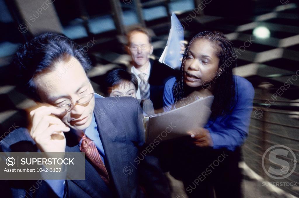 Stock Photo: 1042-3129 Business executives walking up a staircase