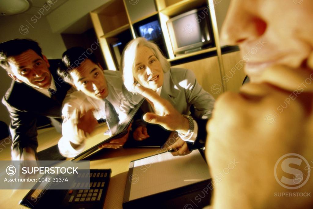Stock Photo: 1042-3137A Three businessmen and a businesswoman in an office