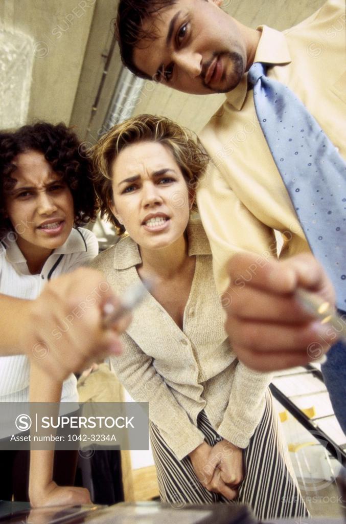 Stock Photo: 1042-3234A Three business executives pointing with pens