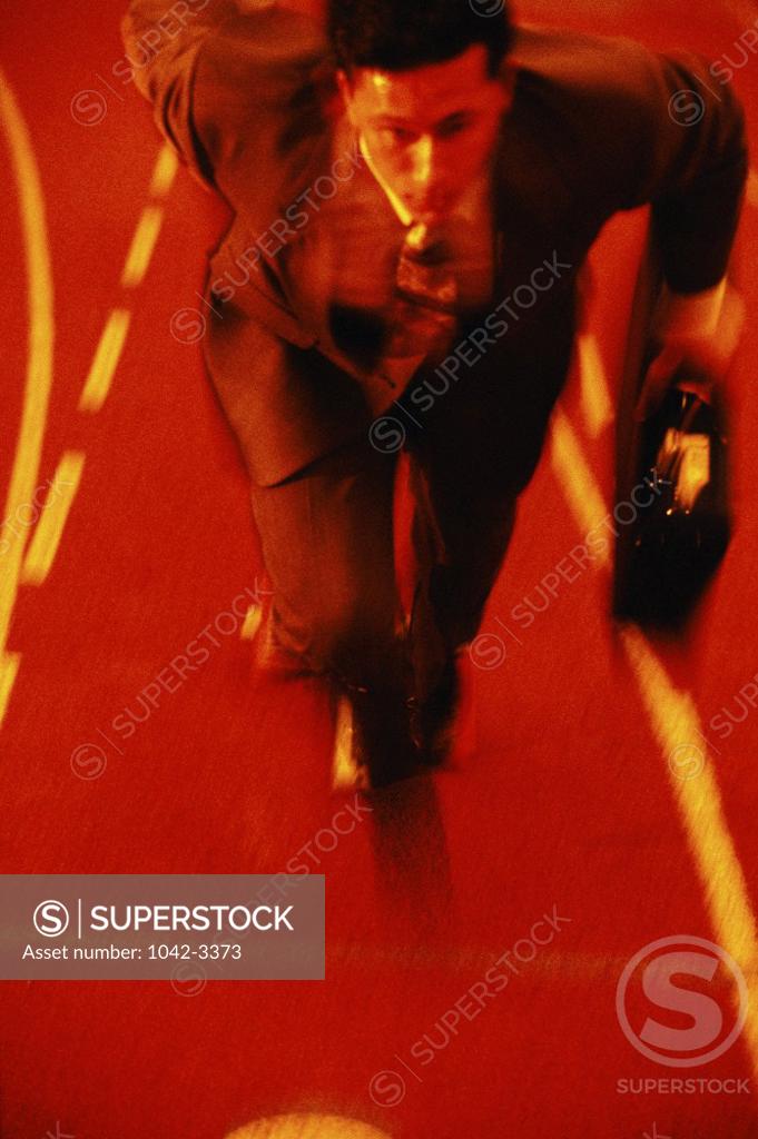 Stock Photo: 1042-3373 Businessman running on a running track