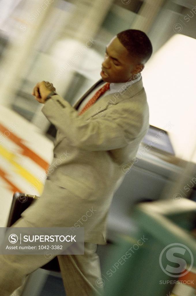 Stock Photo: 1042-3382 Businessman looking at his wristwatch