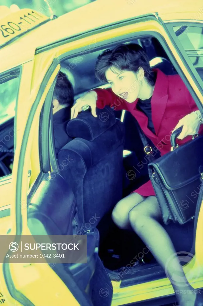 Businesswoman stepping out of a taxi