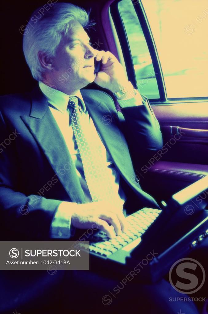 Stock Photo: 1042-3418A Businessman looking out of a window of a car