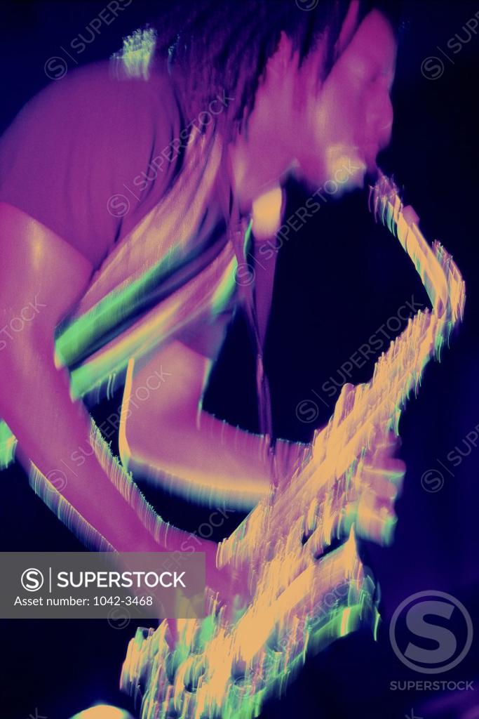 Stock Photo: 1042-3468 Side profile of a young man playing the saxophone