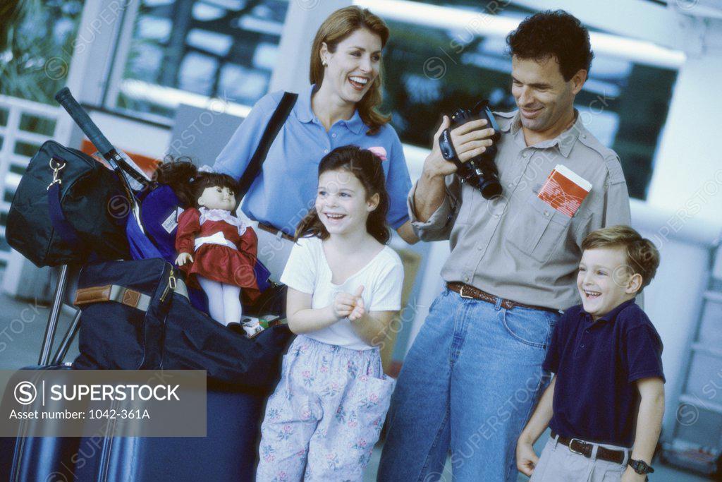 Stock Photo: 1042-361A Parents with their son and daughter at an airport