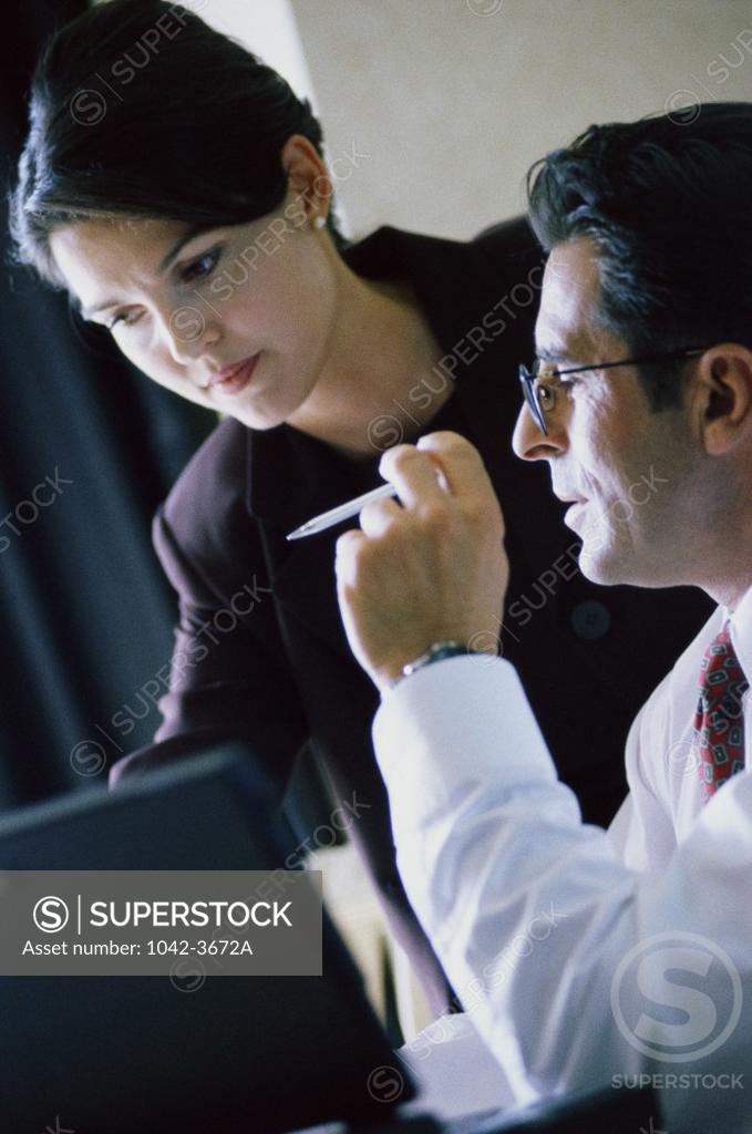 Stock Photo: 1042-3672A Businessman and a businesswoman talking to each other