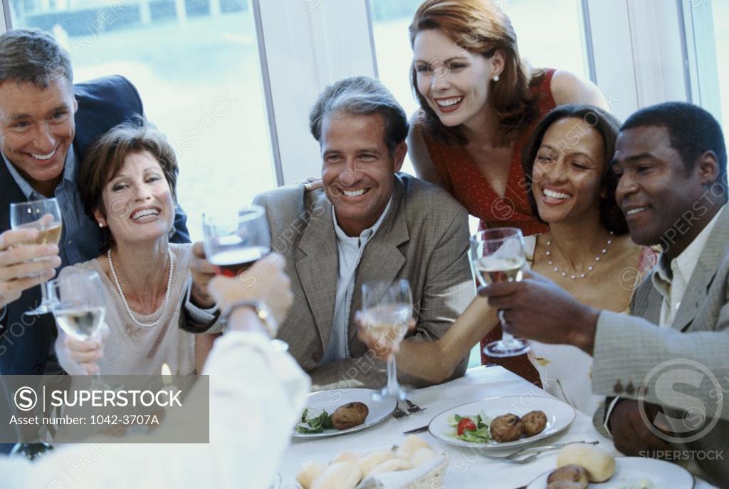 Stock Photo: 1042-3707A Group of men and women toasting with wineglasses