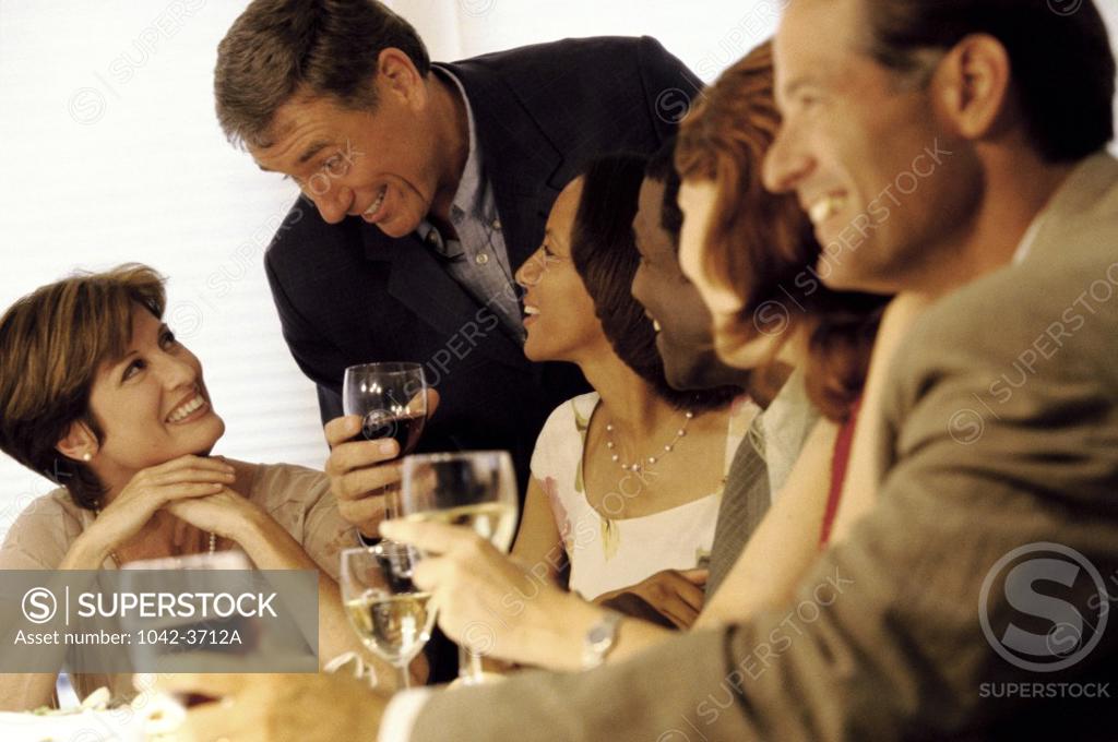Stock Photo: 1042-3712A Group of people celebrating with white wine and red wine