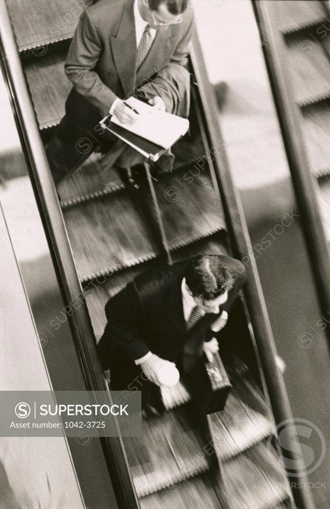 Stock Photo: 1042-3725 High angle view of two businessmen on an escalator