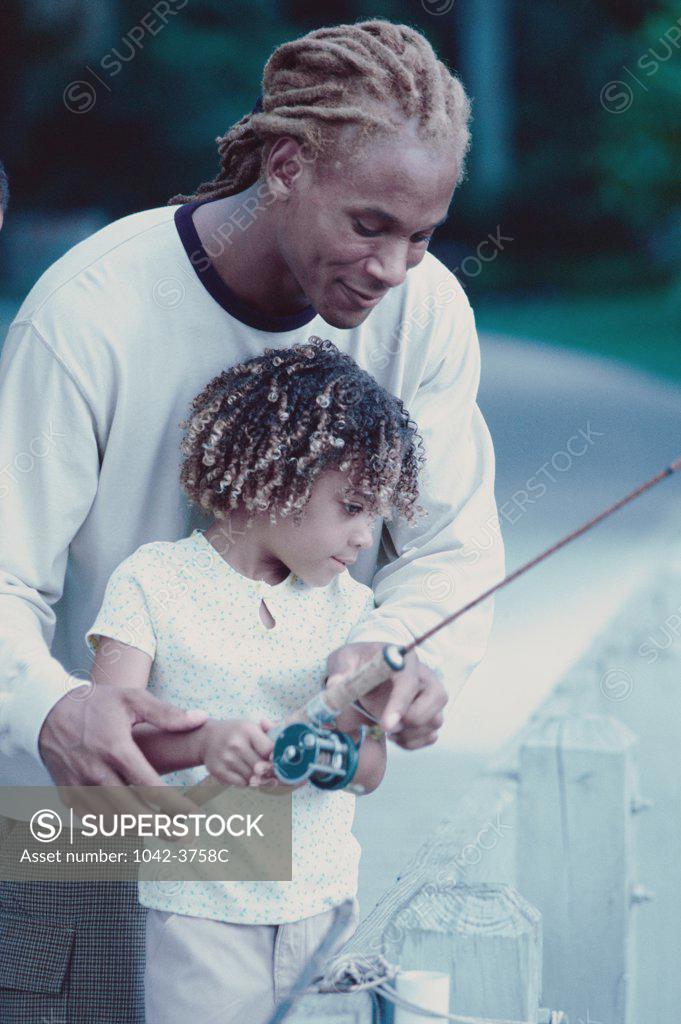 Stock Photo: 1042-3758C Father teaching fishing to his son