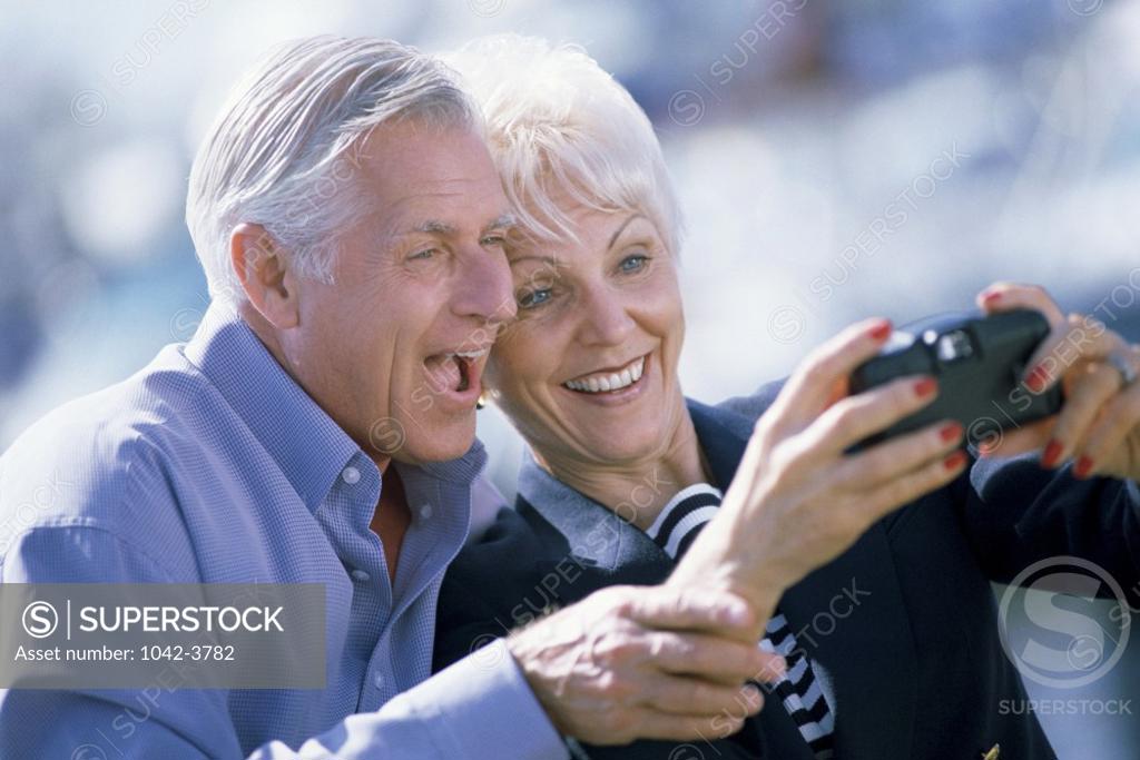 Stock Photo: 1042-3782 Senior couple taking a photo of themselves