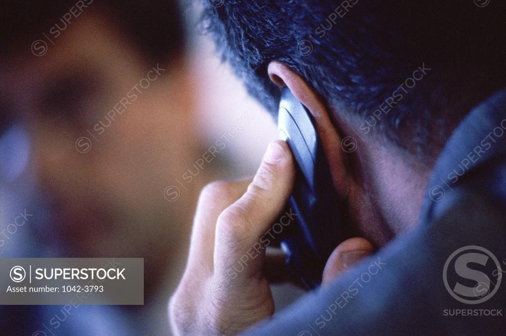 Stock Photo: 1042-3793 Rear view of a businessman talking on a mobile phone