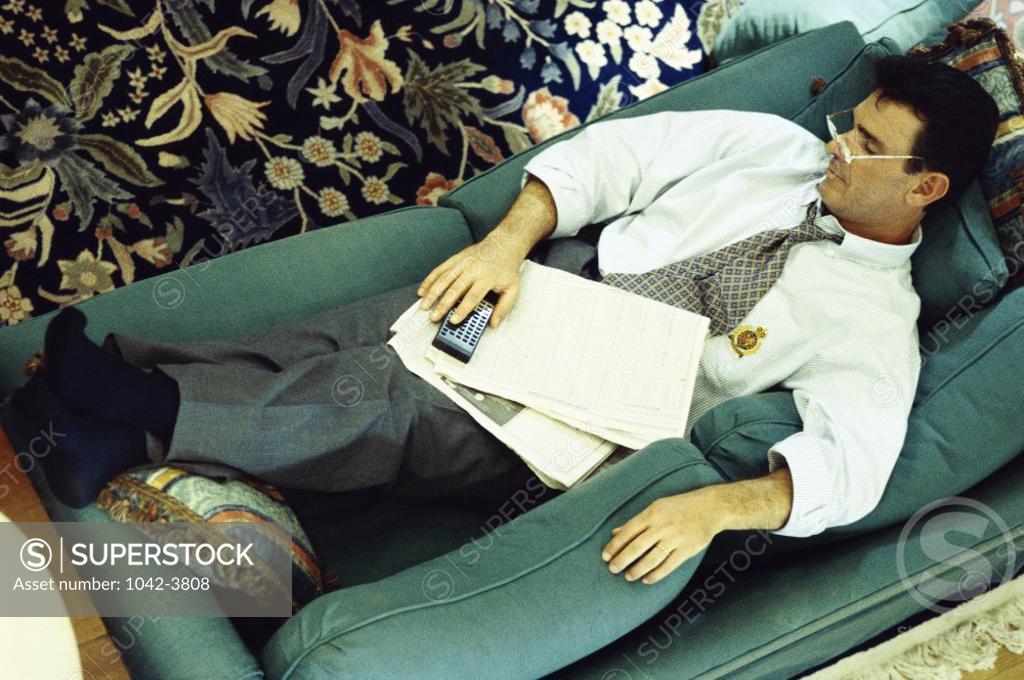 Stock Photo: 1042-3808 Young man sleeping on a couch