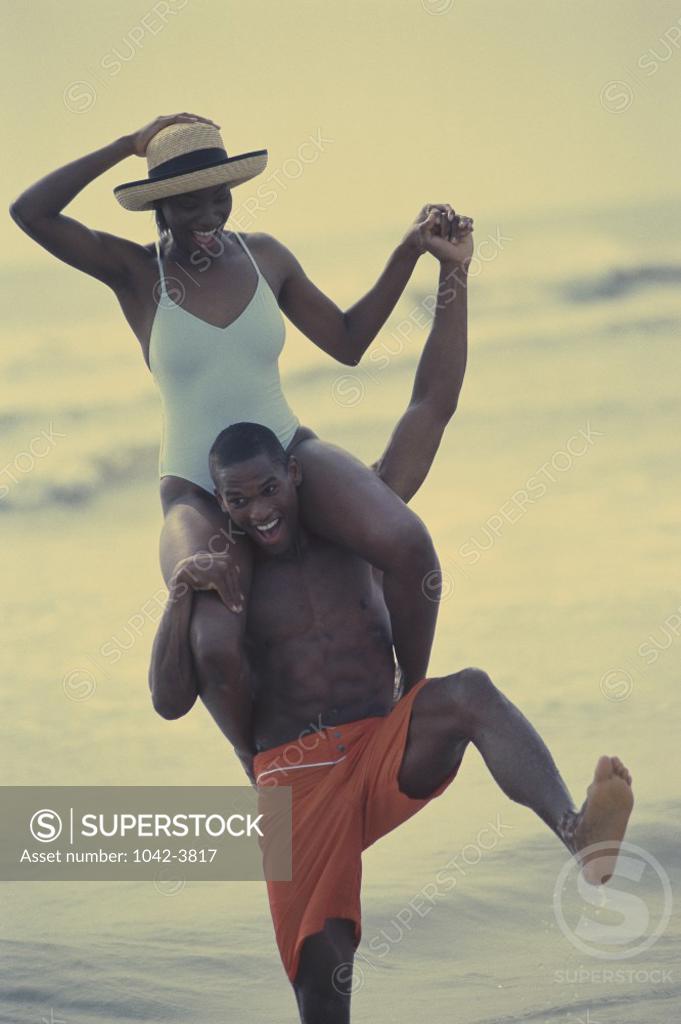 Stock Photo: 1042-3817 Young woman sitting on a young man's shoulders