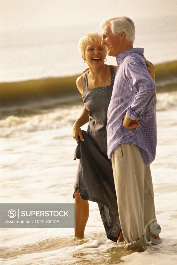 Stock Photo: 1042-3840A Senior couple standing on the beach
