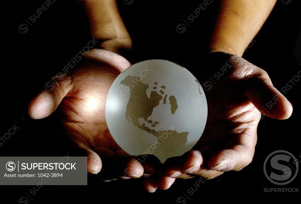 Stock Photo: 1042-3894 Close-up of a person's hands holding a globe