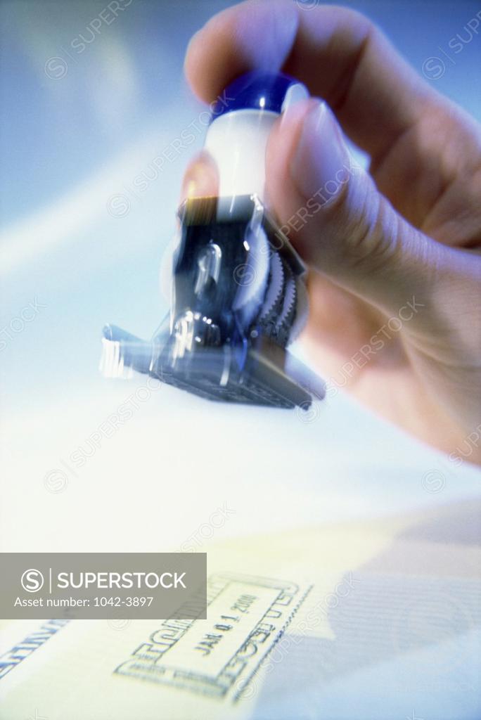 Stock Photo: 1042-3897 Person holding a rubber stamp