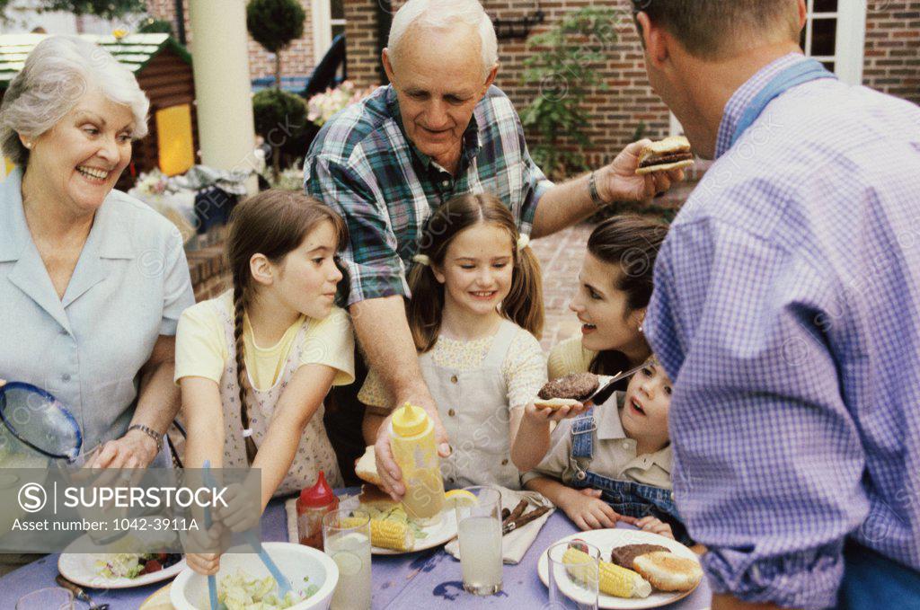 Stock Photo: 1042-3911A Family having lunch at a dining table