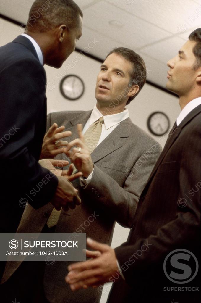Stock Photo: 1042-4003A Three businessmen talking in an office