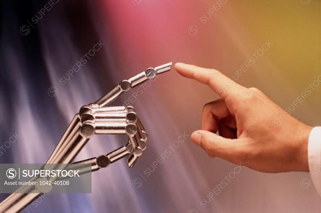 Stock Photo: 1042-4010B Close-up of a person's finger touching a robot's finger