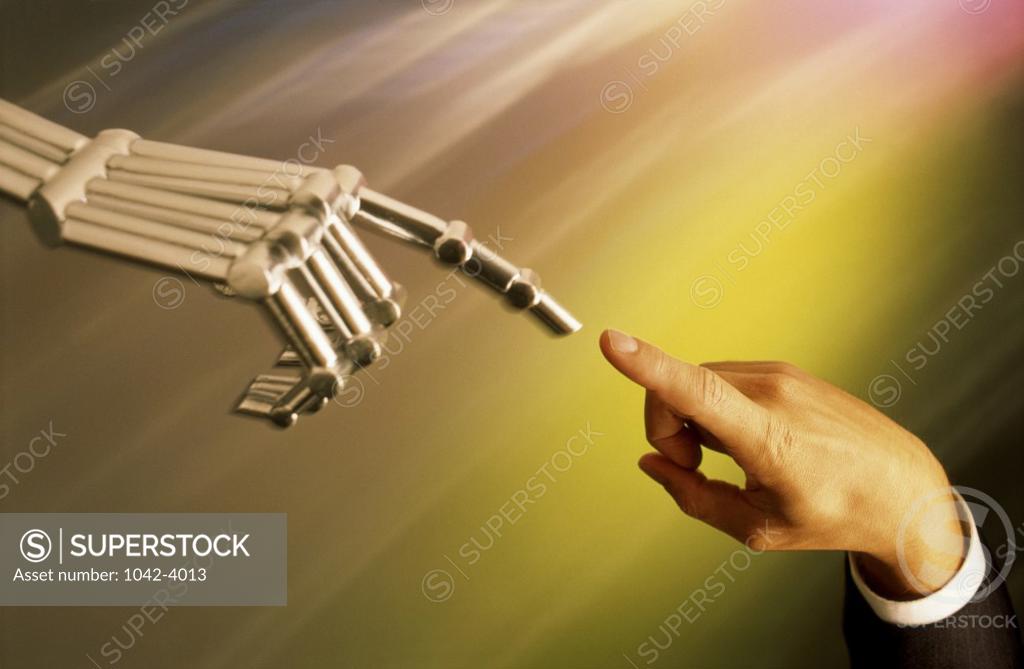 Stock Photo: 1042-4013 Businessman's hand and a robot's hand