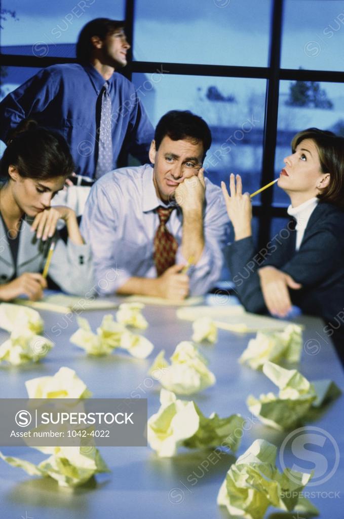 Stock Photo: 1042-4022 Two businessmen and two businesswomen working in an office