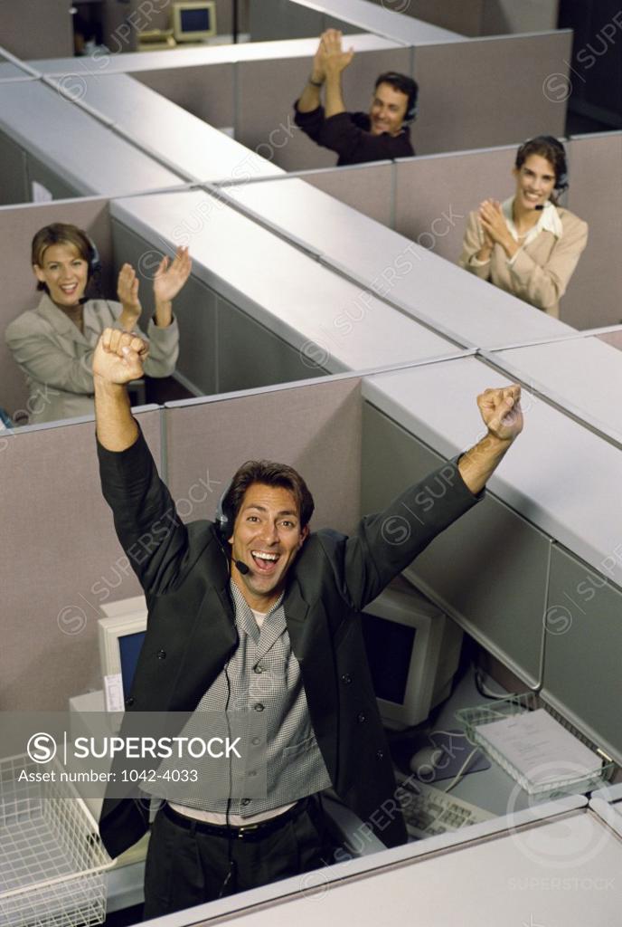 Stock Photo: 1042-4033 Group of business executives in cubicles wearing headsets