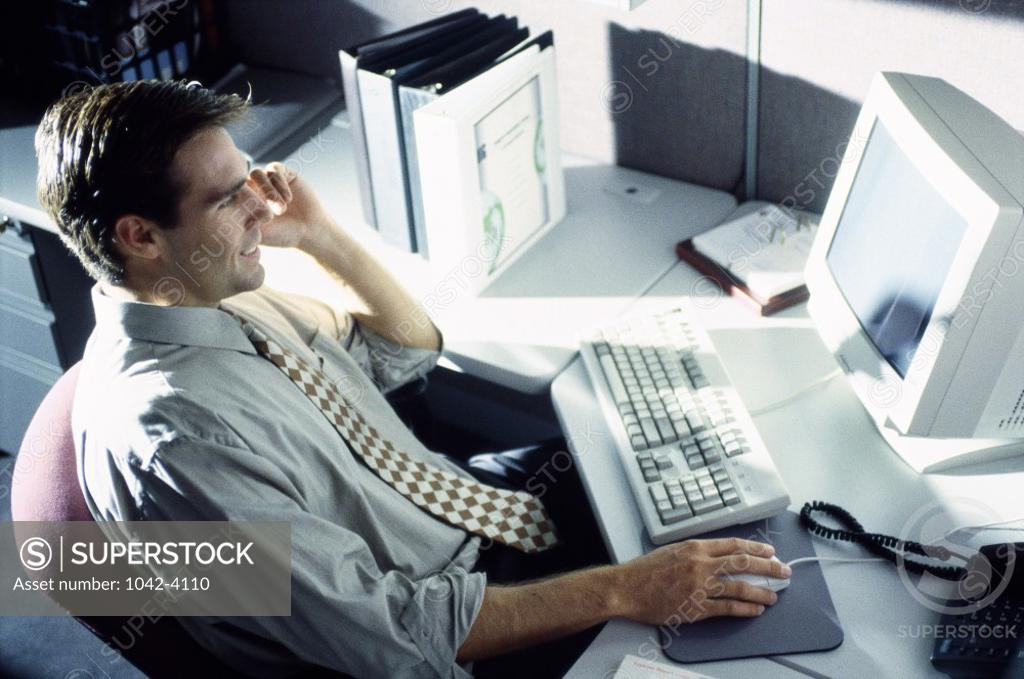 Stock Photo: 1042-4110 Side profile of a businessman using a computer