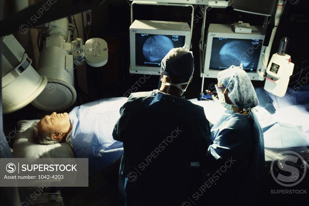 Stock Photo: 1042-4203 High angle view of two doctors examining a patient