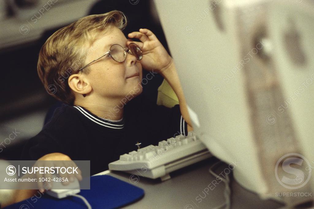 Stock Photo: 1042-4285A Side profile of a boy working on a computer