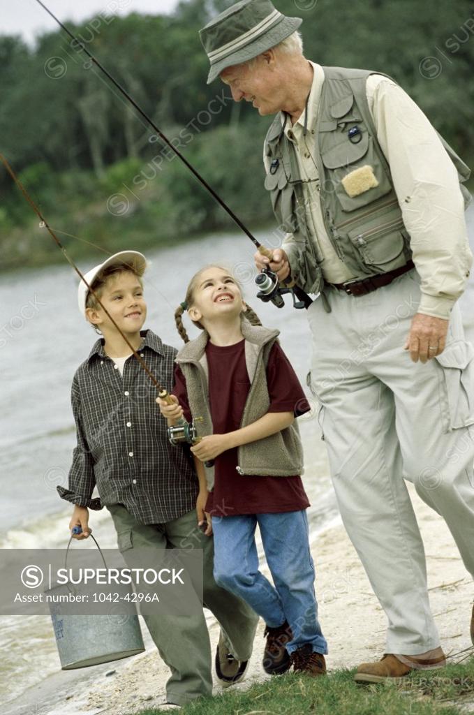 Stock Photo: 1042-4296A Grandfather walking with his grandson and granddaughter