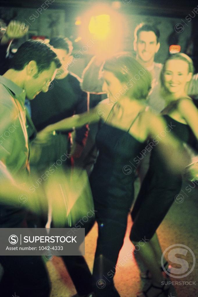 Stock Photo: 1042-4333 Group of people dancing in a nightclub
