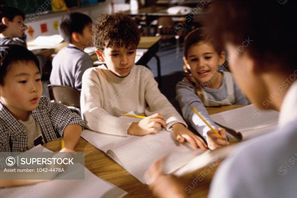 Stock Photo: 1042-4478A Teacher holding flashcards in front of her students