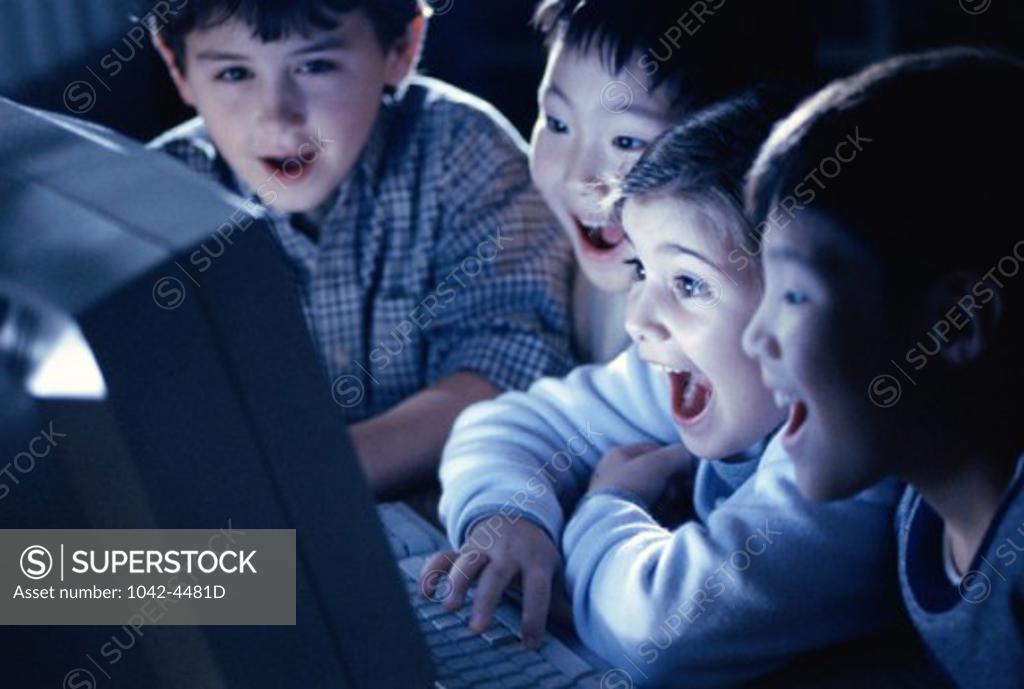 Stock Photo: 1042-4481D Group of boys laughing in front of a computer monitor