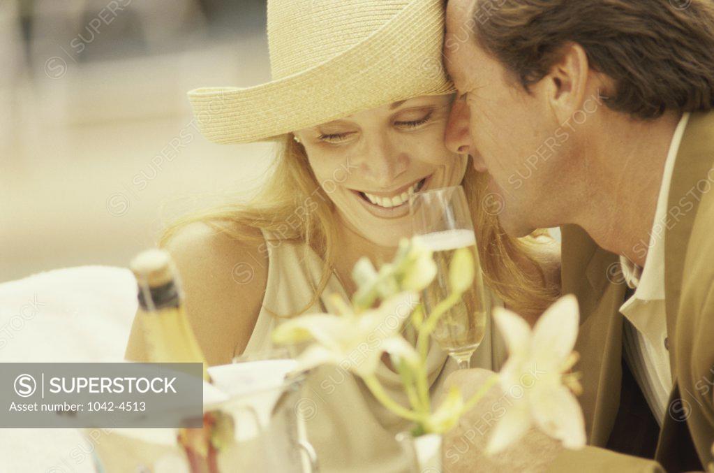 Stock Photo: 1042-4513 Couple nuzzling in an outdoor cafe