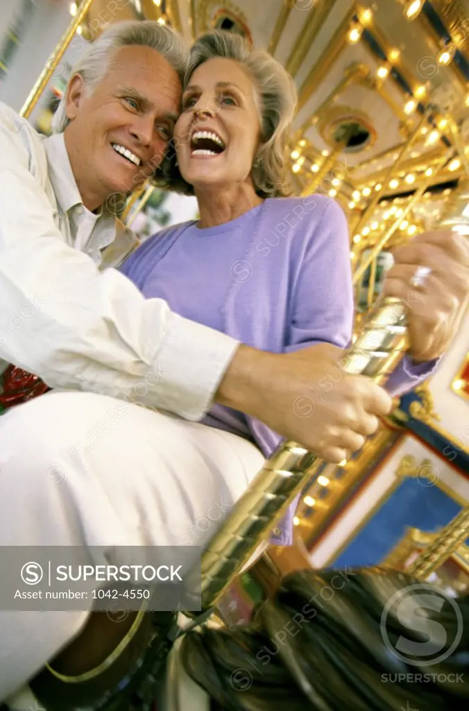 Senior couple together on a merry go round