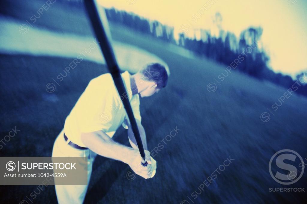 Stock Photo: 1042-4559A High angle view of a mid adult man swinging a golf club